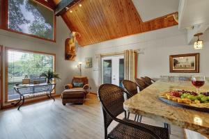 a living room with a table with a bowl of fruit on it at Gettin' Guada loopy with Hot Tub & Riverfront in Schumannsville