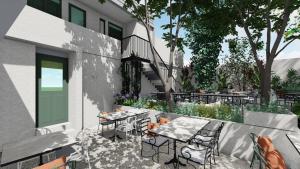 a patio with tables and chairs next to a building at Kentrikon 1924 Boutique Hotel, Paphos Old Town in Paphos City