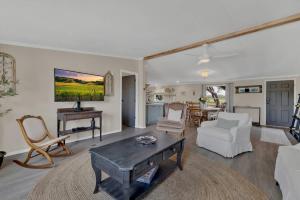 a living room with a couch and a table at Sage: Peaceful Hill Country Retreat with Hot-Tub! in Morris Ranch