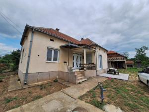 a house with a car parked in front of it at Tomić in Rutevac