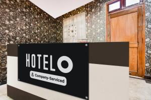 a hotel sign in a room with a door at Super OYO Hotel O Amhat Sultanpur City in Sultānpur