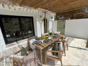 a dining table and chairs on a patio at Finca Celia Competa in Cómpeta