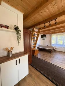 a large living room with a staircase and a bedroom at Csillag kulcsoshaz in Gheorgheni