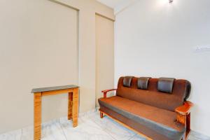 a bench in a room with a table at Super Collection O Westhill Near Govt Engg College in Calicut