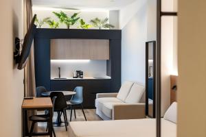 a living room with a white couch and a table at Cool Lofts Boutique Castellón in Castellón de la Plana