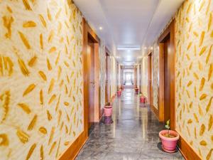 a hallway with a row of potted plants at Super Townhouse Ramamurthy Nagar West Formerly Phoenix Hotel in Bangalore +51 photos