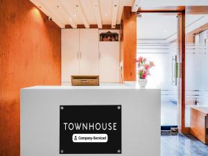 a white counter with a townhouse sign on it at Super Townhouse Ramamurthy Nagar West Formerly Phoenix Hotel in Bangalore