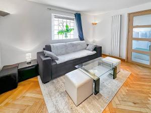 a living room with a couch and a table at Maison conviviale - Proche aéroport Roissy in Le Blanc-Mesnil