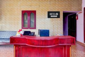 a red desk in front of a building at Hotel O Nemeli Road Sriram Nagar in Chennai