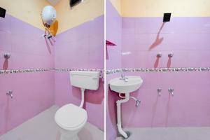 a pink bathroom with a toilet and a sink at Hotel O Nemeli Road Sriram Nagar in Chennai