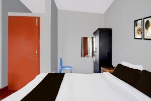 Un dormitorio con una cama y una puerta roja. en Super Collection O SRS Residency, en Shillong