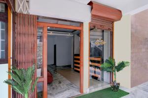 a room with orange columns and a glass door at Super Collection O SRS Residency in Shillong +42 photos