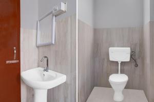 a bathroom with a white toilet and a sink at Super Collection O SRS Residency in Shillong