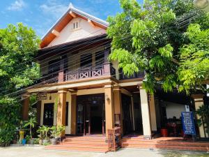 a house with a balcony on top of it at Maison Vongprachan Legend in Luang Prabang