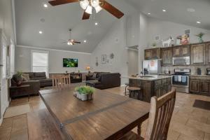 a kitchen and living room with a wooden table at Let's Go Tubing! Awesome House-Next to River! in Third Crossing