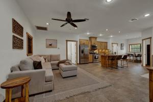 a living room with a couch and a ceiling fan at Oakridge Ranch - Pool,Hot Tub, Pickleball Court, Whiskey & Wine Room in Johnson City