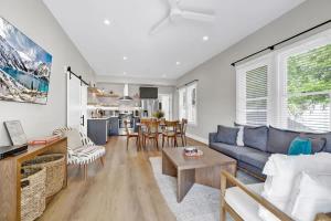 a living room with a blue couch and a table at The Grove-A: Cozy Cottage 2-Blocks to Marktplatz! in Fredericksburg