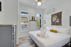 a bedroom with a large white bed with two stuffed animals on it at Resort at Fredericksburg Unit 25 in Rocky Hill