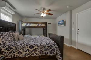 a bedroom with a bed and a ceiling fan at Let's Go Tubing! Awesome House-Next to River! in Third Crossing
