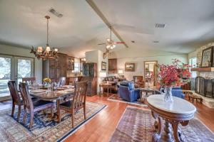 a dining room and living room with a table and chairs at StunningHome on The Blanco River in Flugrath
