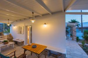 a patio with a wooden table and chairs at Villa Lena in Stelida
