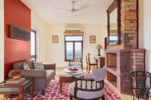 a living room with a couch and a fireplace at Ramathra Fort in Sapotra