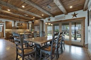 a dining room with a wooden table and chairs at West End Lodge Resort Style Pool! in Fredericksburg