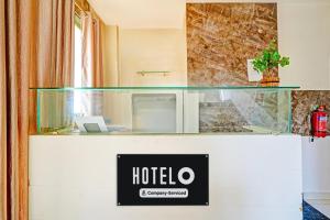 a hotel sign on the counter of a hotel room at Super Hotel O Kaveri Road Mysore Formerly Hotel Nisarga in Mysore