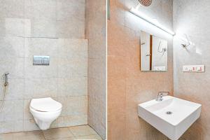 a bathroom with a toilet and a sink at Super Hotel O Kaveri Road Mysore Formerly Hotel Nisarga in Mysore