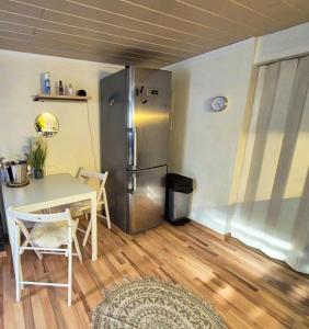 a kitchen with a table and a refrigerator at Erholung zwischen Tier und Natur in Großkmehlen