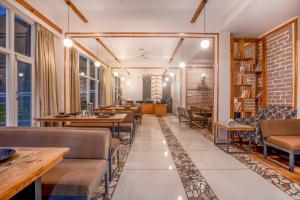 a restaurant with tables and chairs and a brick wall at Deva's Retreat in Joshīmath