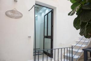 a glass door on the side of a building at Holiday House Trapani in Trapani