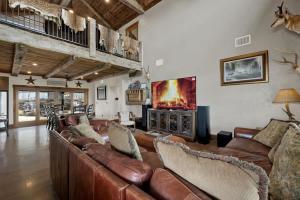 a living room with leather couches and a fireplace at West End Lodge Resort Style Pool! in Fredericksburg