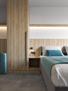 a bedroom with a bed and a wooden wall at Hotel Zdravilisce - Thermana Lasko in Laško