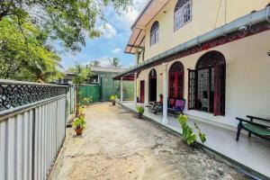 an empty courtyard of a house with a fence at Tree Breeze in Negombo