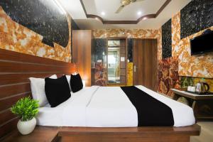 a bedroom with a large bed in a room at Collection O Tikonia Formerly Hotel Jatin in Haldwāni +36 photos