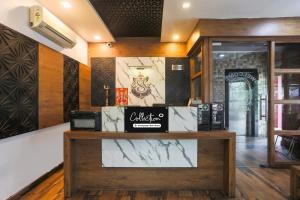 a store with a counter with a sign on it at Collection O Tikonia Formerly Hotel Jatin in Haldwāni
