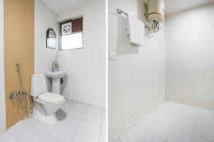 a bathroom with a toilet and a sink at Collection O Tikonia Formerly Hotel Jatin in Haldwāni
