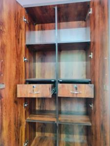 a wooden wall with wooden shelves in a room at venkateshwara ladies pg in Bengaluru