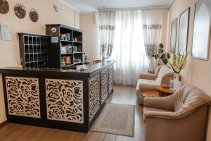 a living room with a large wooden entertainment center at Pysanka Hotel in Kolomiya