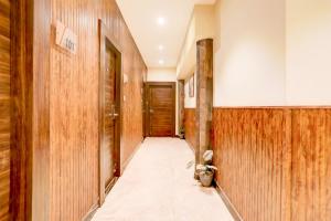 a hallway with wood paneled walls and a door at Palette by CheckIn Patliputra Colony Formerly The Aurum in Patna