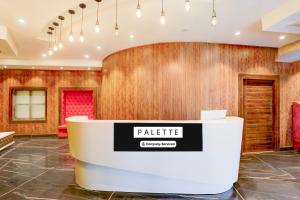 a lobby with a table in front of a wooden wall at Palette by CheckIn Patliputra Colony Formerly The Aurum in Patna