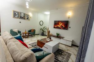 a living room with a couch and a fireplace at The Nest Kampala in Katale