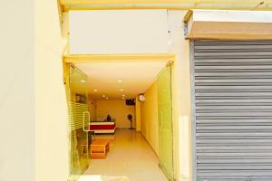 a hallway of a building with a door and a table at Collection O Surathkal Beach Formerly Coastal Lodge in Suratakal