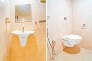 a bathroom with a toilet and a sink and a shower at Collection O Surathkal Beach Formerly Coastal Lodge in Suratakal