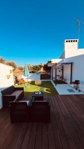 a wooden deck with a table and a patio at Paraíso a Dois em Estremoz in Estremoz