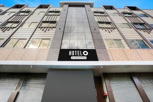 a hotel sign on the side of a building at Hotel O Kota Railway Junction Formerly Formerly Aagam Inn in Kota