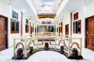 a bed in a room with a ceiling at Hotel O by OYO Subhani Building Formerly Hotel Amandeep in Ludhiana
