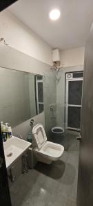a bathroom with a toilet and a sink at Private Studio Apartment in Dhamni