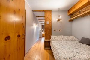 a bedroom with a bed and a wooden floor at Casa Andrea vista Monte Bianco in Pila